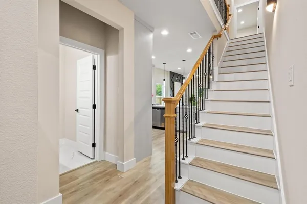 a view of entryway with wooden floor and stairs