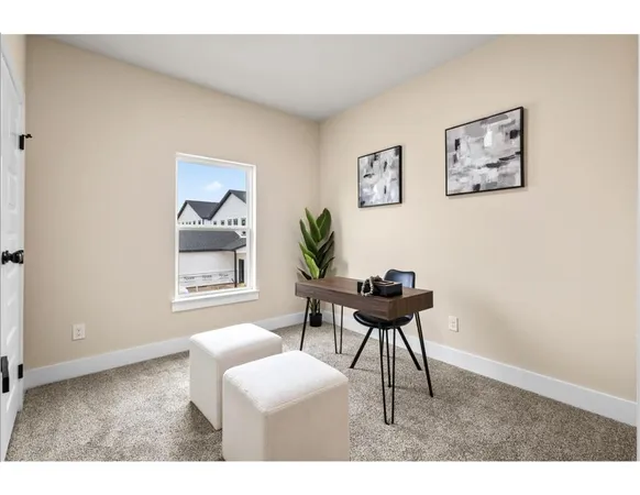 a living room with furniture a desk and chair with a mirror