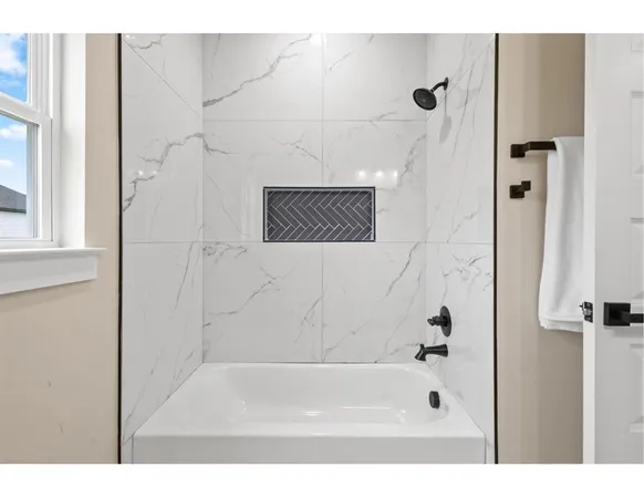 a bathroom with a bathtub and shower