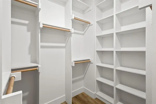 a view of walk in closet with empty racks