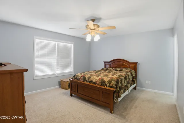 a bathroom with a sink a toilet and shower curtain