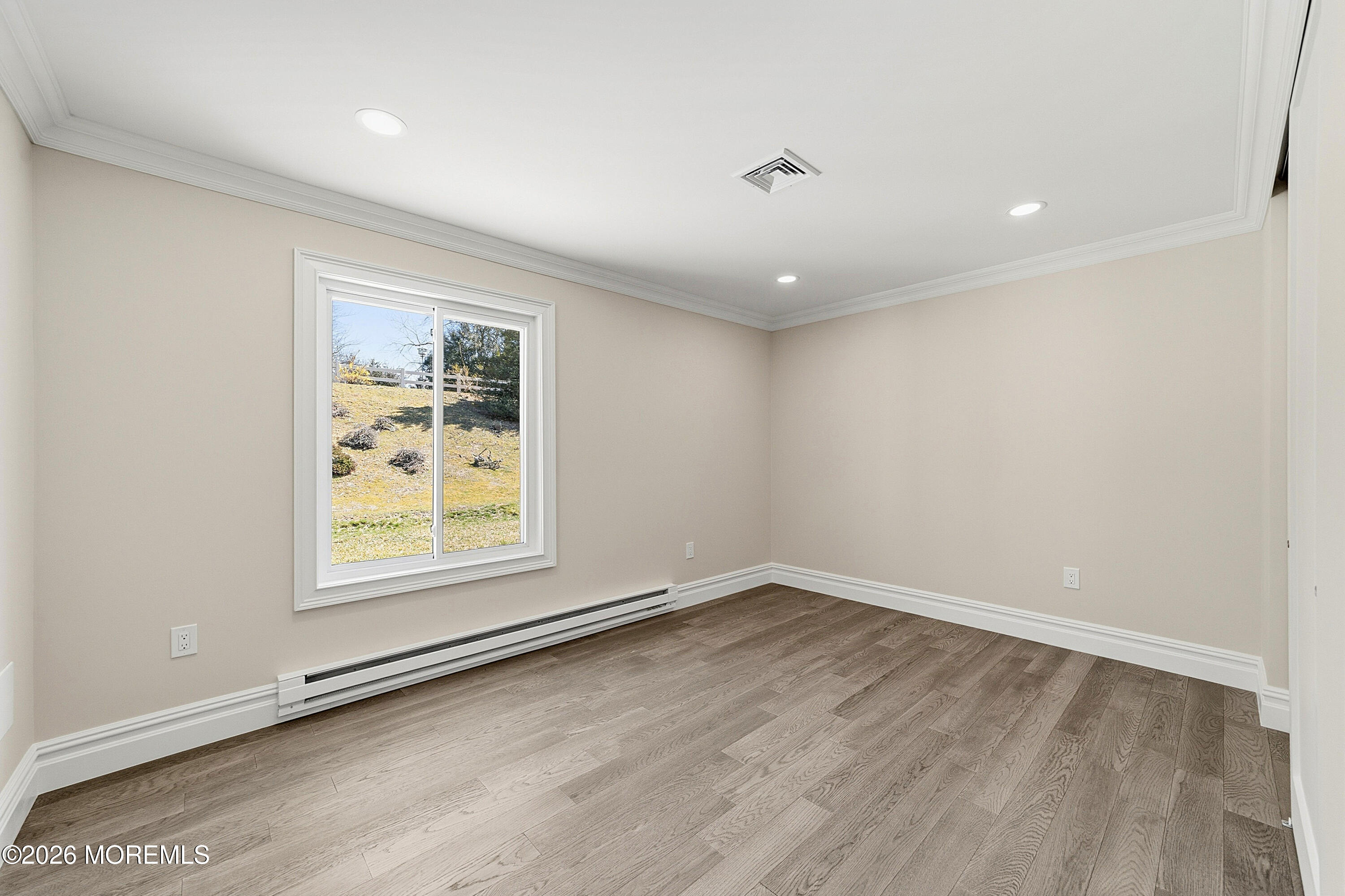780 B Ardmore Road, Unit 780B Monroe Township, NJ 08831 - Photo 18 of 30 an empty room with wooden floor and windows