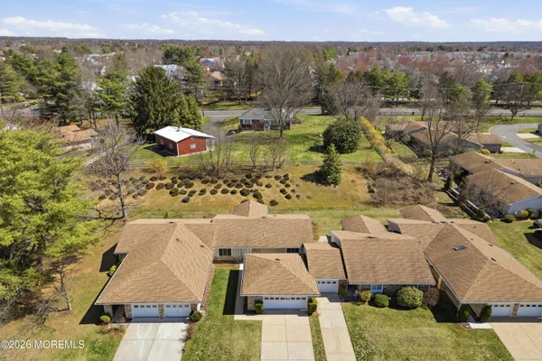an aerial view of residential houses with outdoor space and swimming pool
