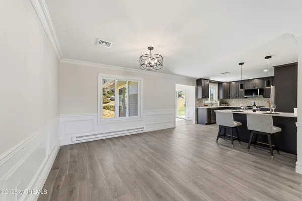 a view of kitchen with furniture and wooden floor