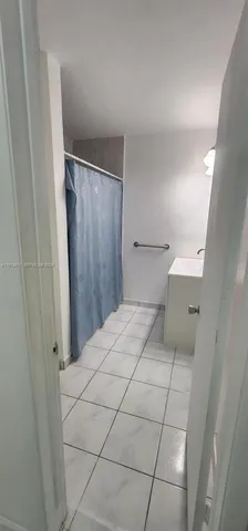 a bedroom with a bed and a shower