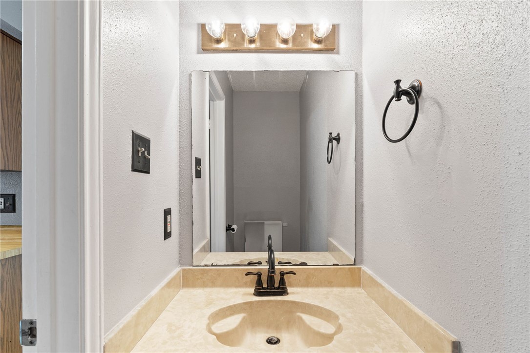 6702 Everhart Road, Unit G105 Corpus Christi, TX 78413 - Photo 15 of 17 a bathroom with a sink and a mirror
