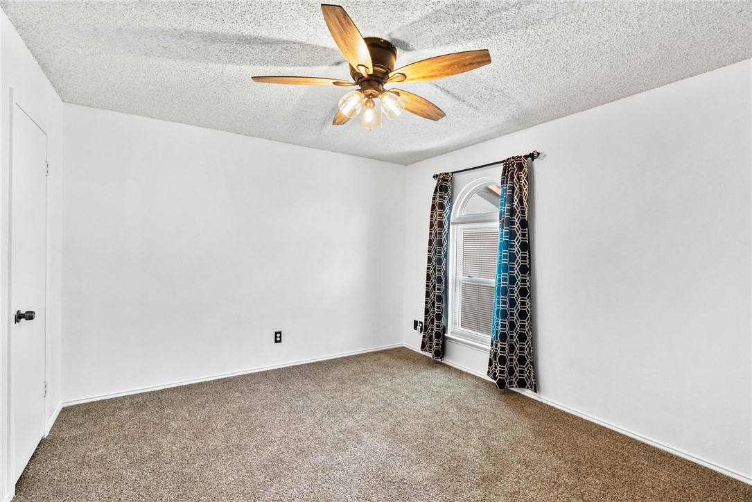 6702 Everhart Road, Unit G105 Corpus Christi, TX 78413 - Photo 8 of 17 an empty room with closet and fan