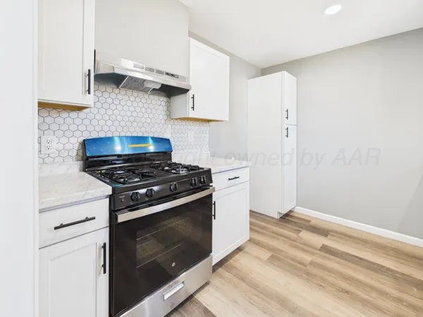a kitchen with a stove and a sink