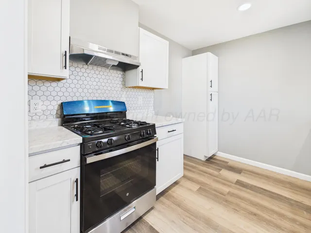 a kitchen with a stove and a sink