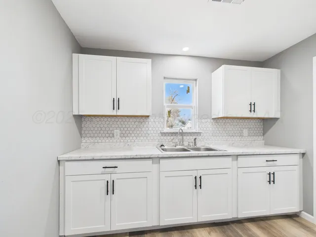 a kitchen with white cabinets