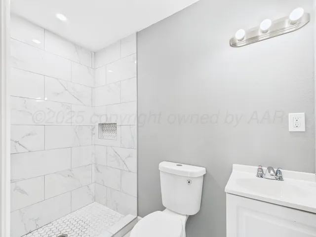 a bathroom with a toilet sink and shower