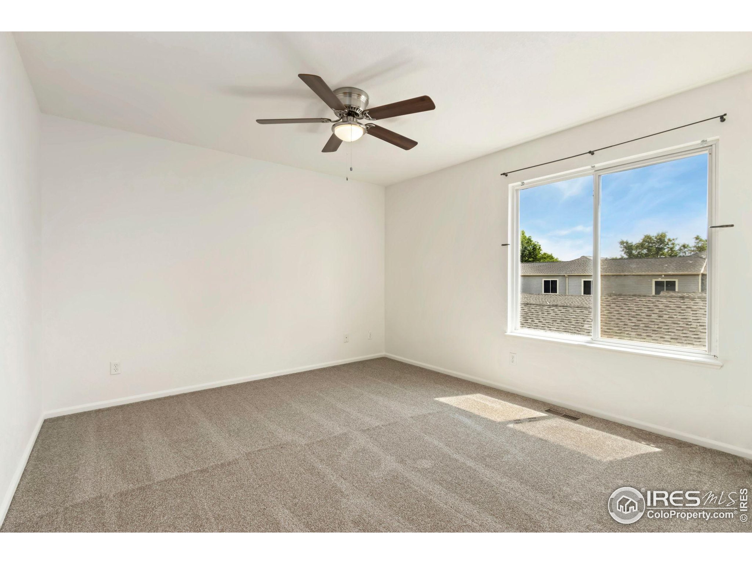 2925 West Stuart Street, Unit 11 Fort Collins, CO 80526 - Photo 14 of 34 a view of an empty room with a window