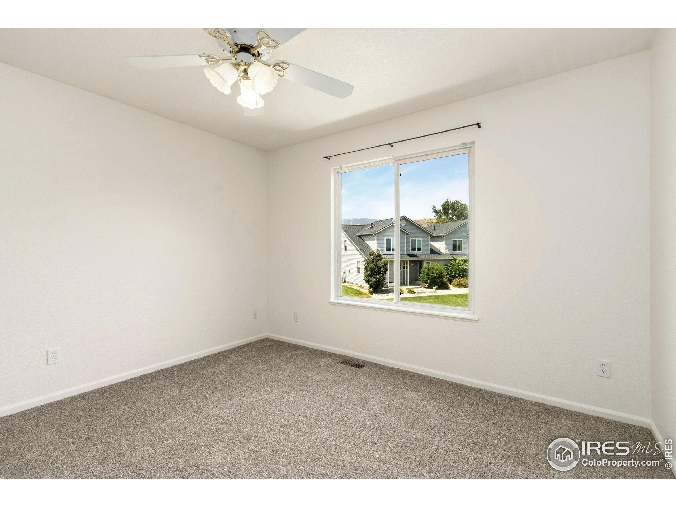 2925 West Stuart Street, Unit 11 Fort Collins, CO 80526 - Photo 22 of 34 a view of an empty room with window and closet