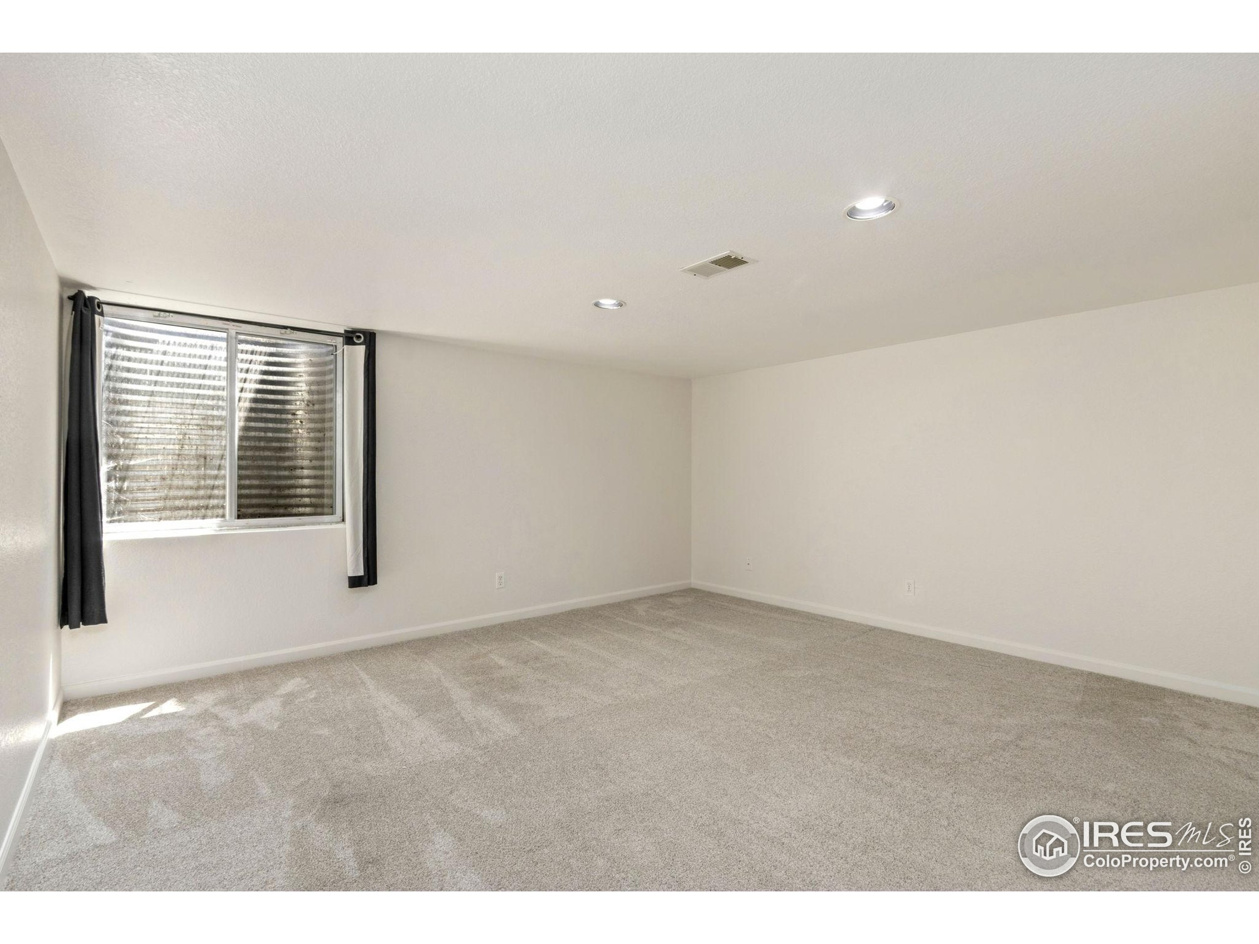 2925 West Stuart Street, Unit 11 Fort Collins, CO 80526 - Photo 30 of 34 a view of an empty room with a window