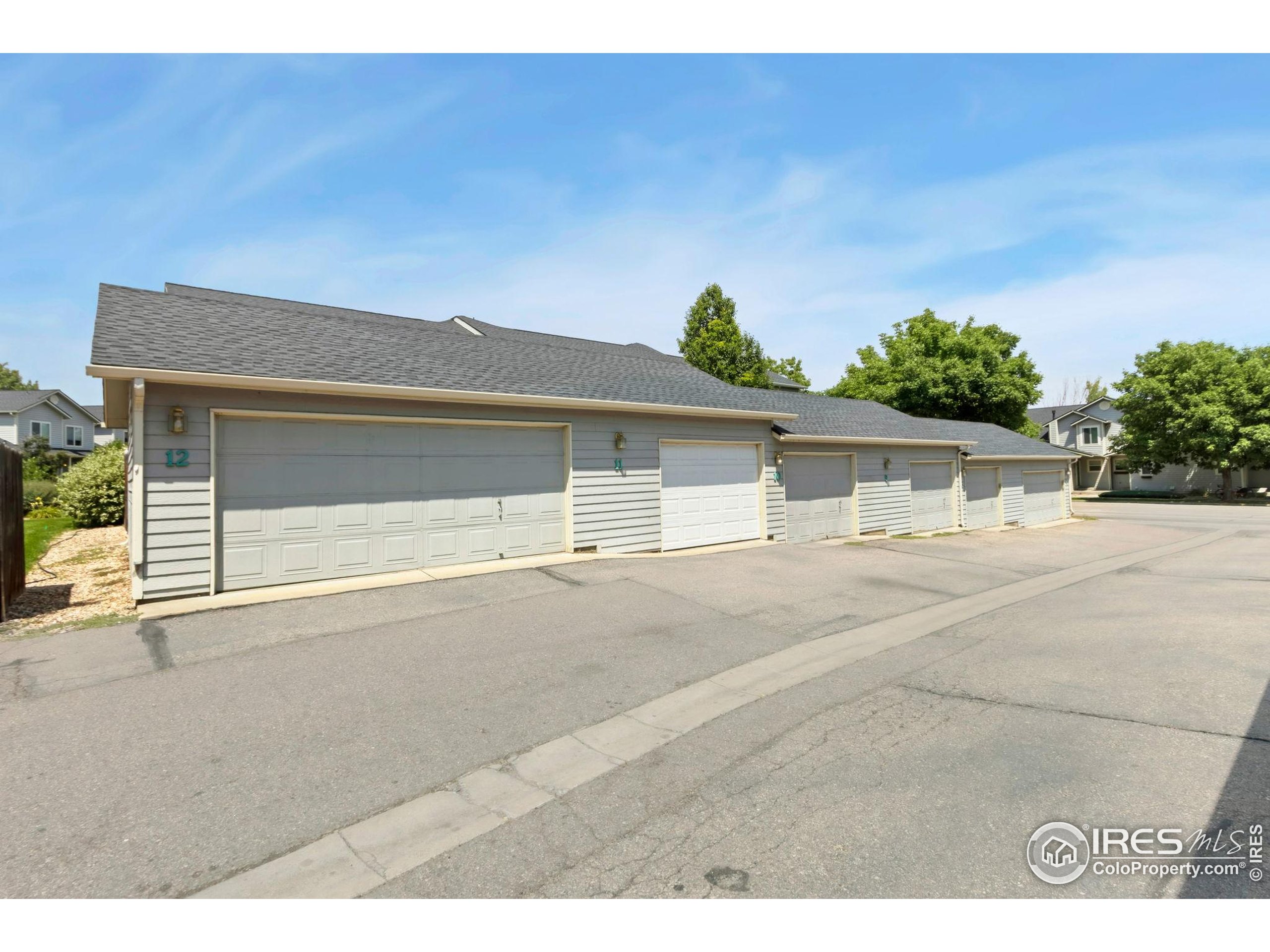 2925 West Stuart Street, Unit 11 Fort Collins, CO 80526 - Photo 31 of 34 a front view of a house with a yard and garage