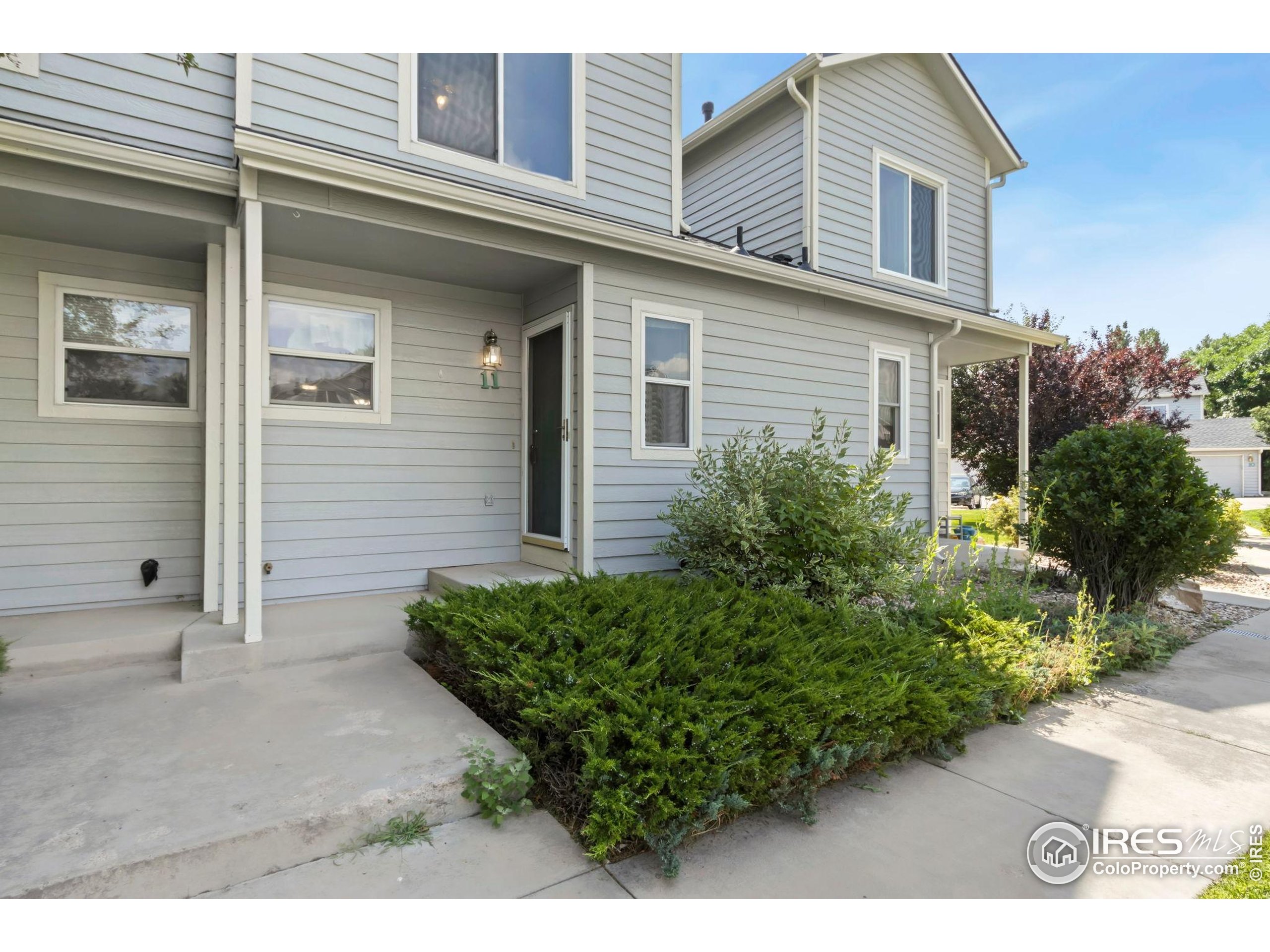 2925 West Stuart Street, Unit 11 Fort Collins, CO 80526 - Photo 33 of 34 a view of a house with potted plants