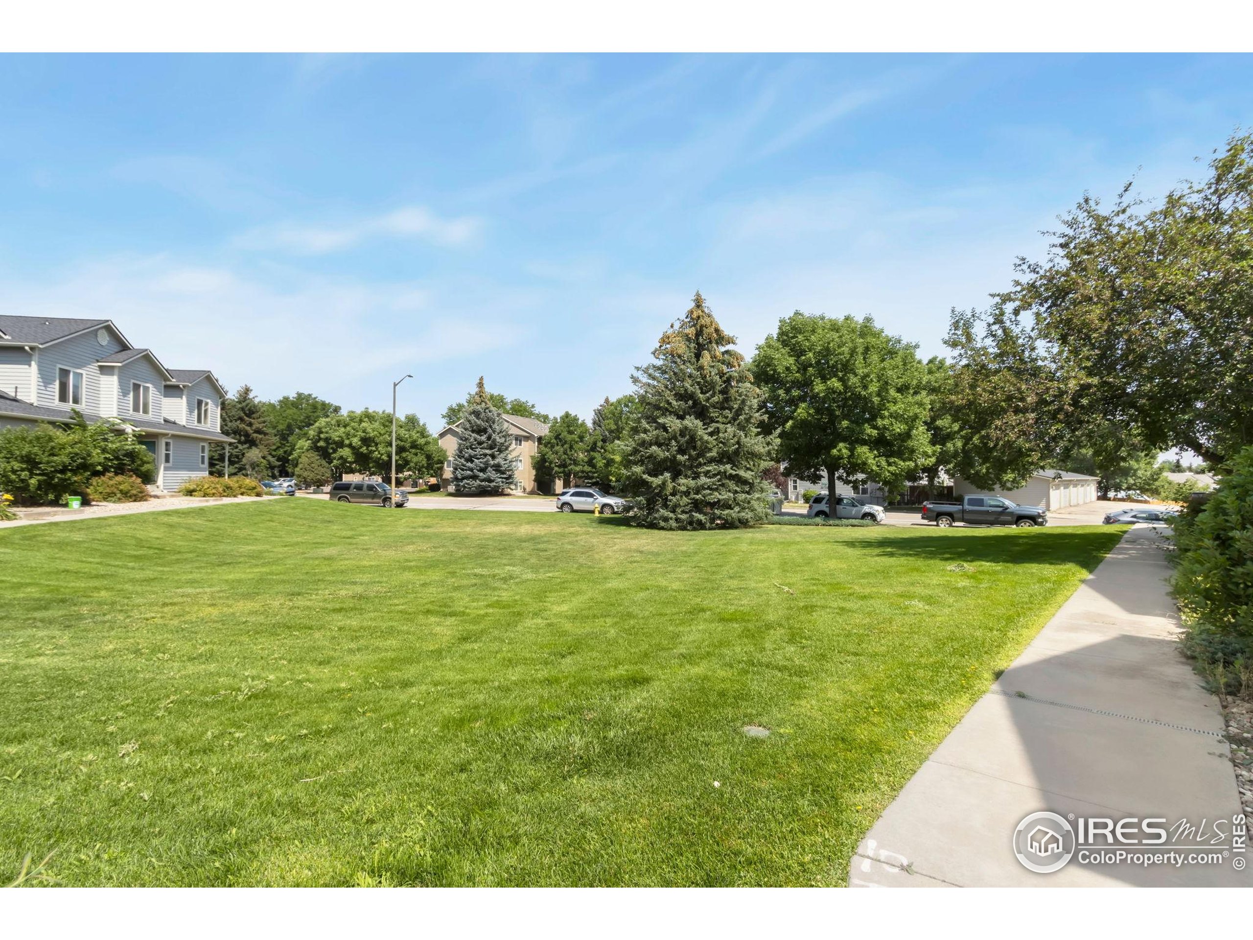2925 West Stuart Street, Unit 11 Fort Collins, CO 80526 - Photo 34 of 34 a view of yard with swimming pool and trees