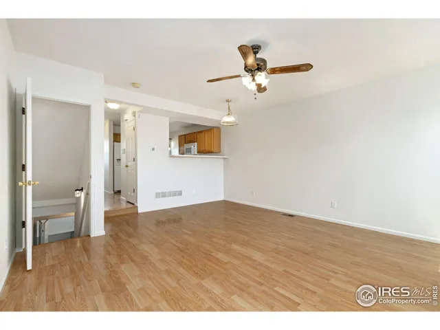 a view of empty room with wooden floor
