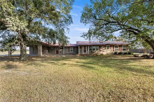 a front view of a house with a yard table and chairs