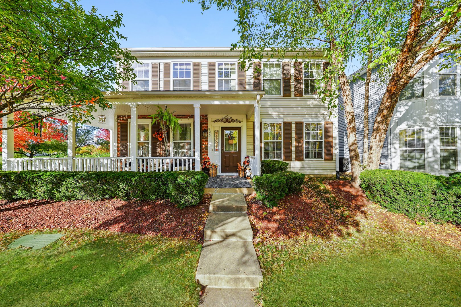 front view of a brick house with a yard