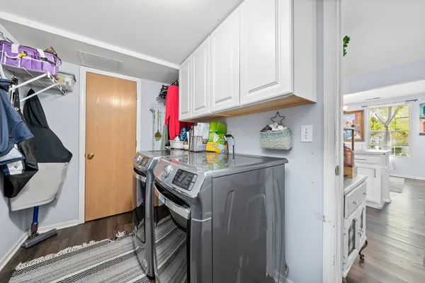 a utility room with cabinets washer and dryer