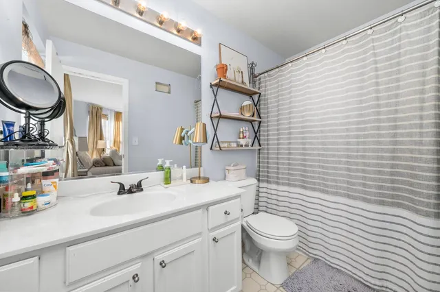 an aerial view of a house with a garden and lake view