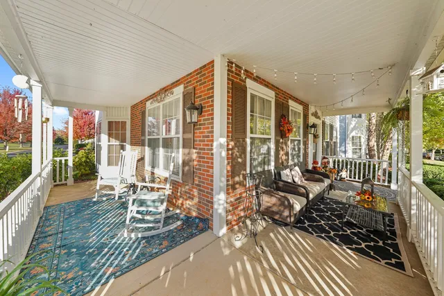 a front view of a house with a yard and potted plants