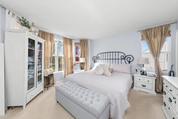 a bedroom with a large bed and a large window