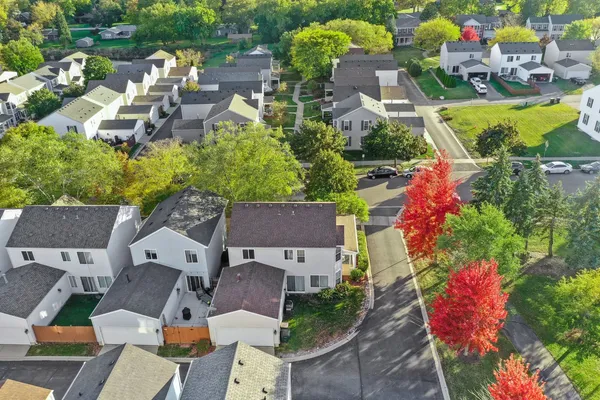 an aerial view of a house with a garden and lake view