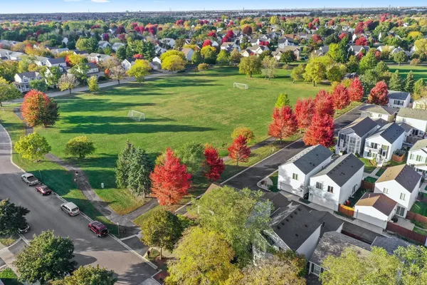 an aerial view of a house with a garden and lake view