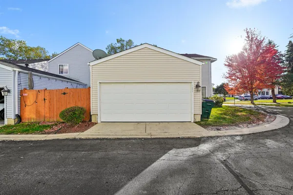 a view of a house with a yard and garage