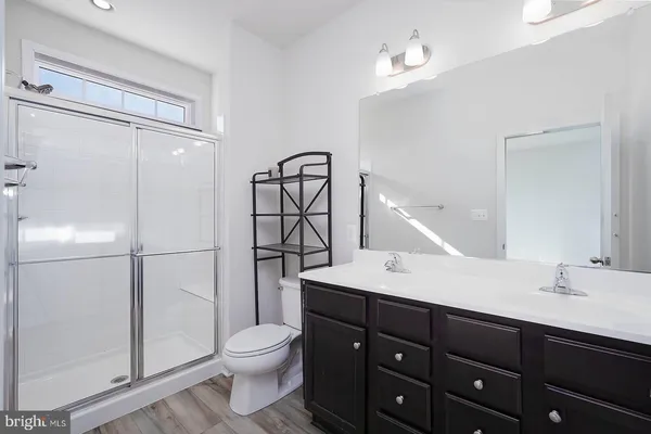 a bathroom with a toilet a sink and mirror
