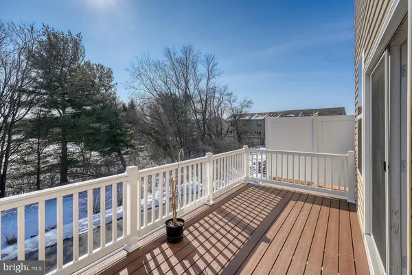a view of a roof deck with wooden floor and fence