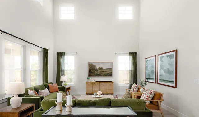 a living room with furniture and large windows