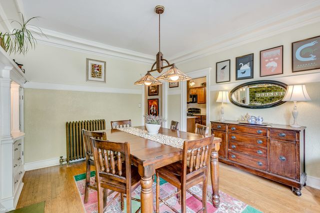 a view of a dining room with furniture and chandelier