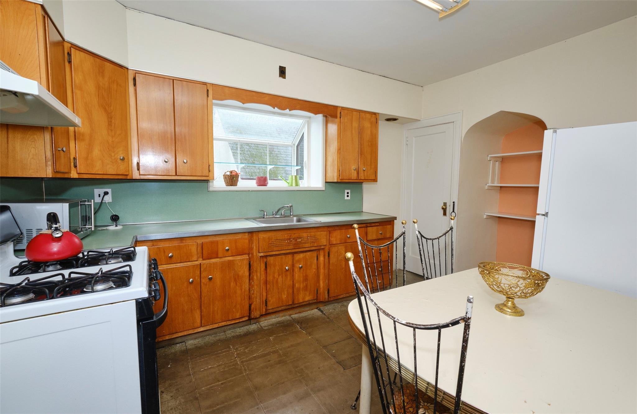 135-47 229th Street Queens, NY 11413 - Photo 12 of 36 Kitchen featuring wood cabinetry, range with gas cooktop, under cabinet range hood, and a sink