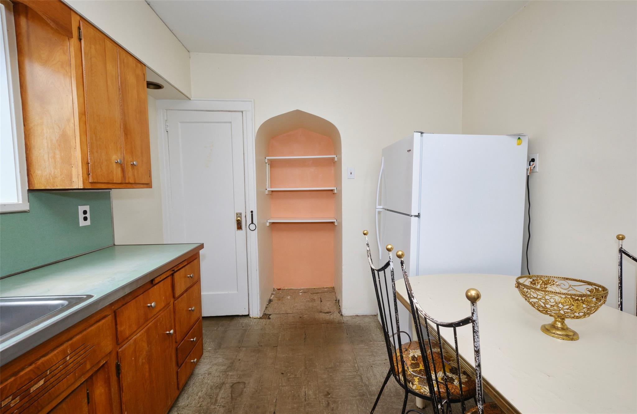 135-47 229th Street Queens, NY 11413 - Photo 13 of 36 Kitchen with freestanding refrigerator, light countertops, a sink, and brown cabinets