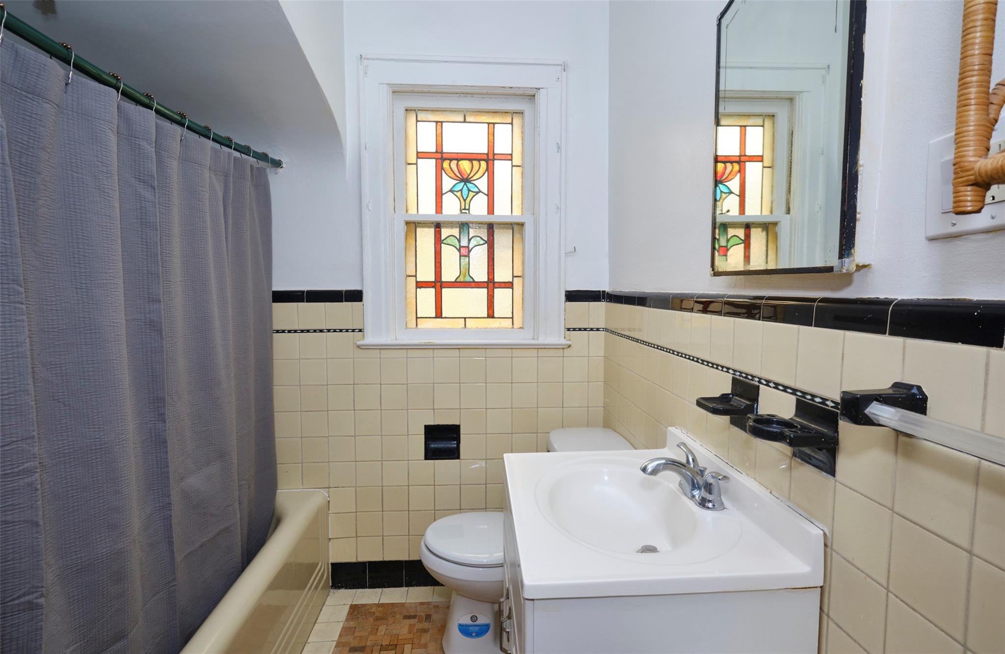 135-47 229th Street Queens, NY 11413 - Photo 15 of 36 Full bathroom with vanity, tile walls, toilet, tile patterned floors, and wainscoting