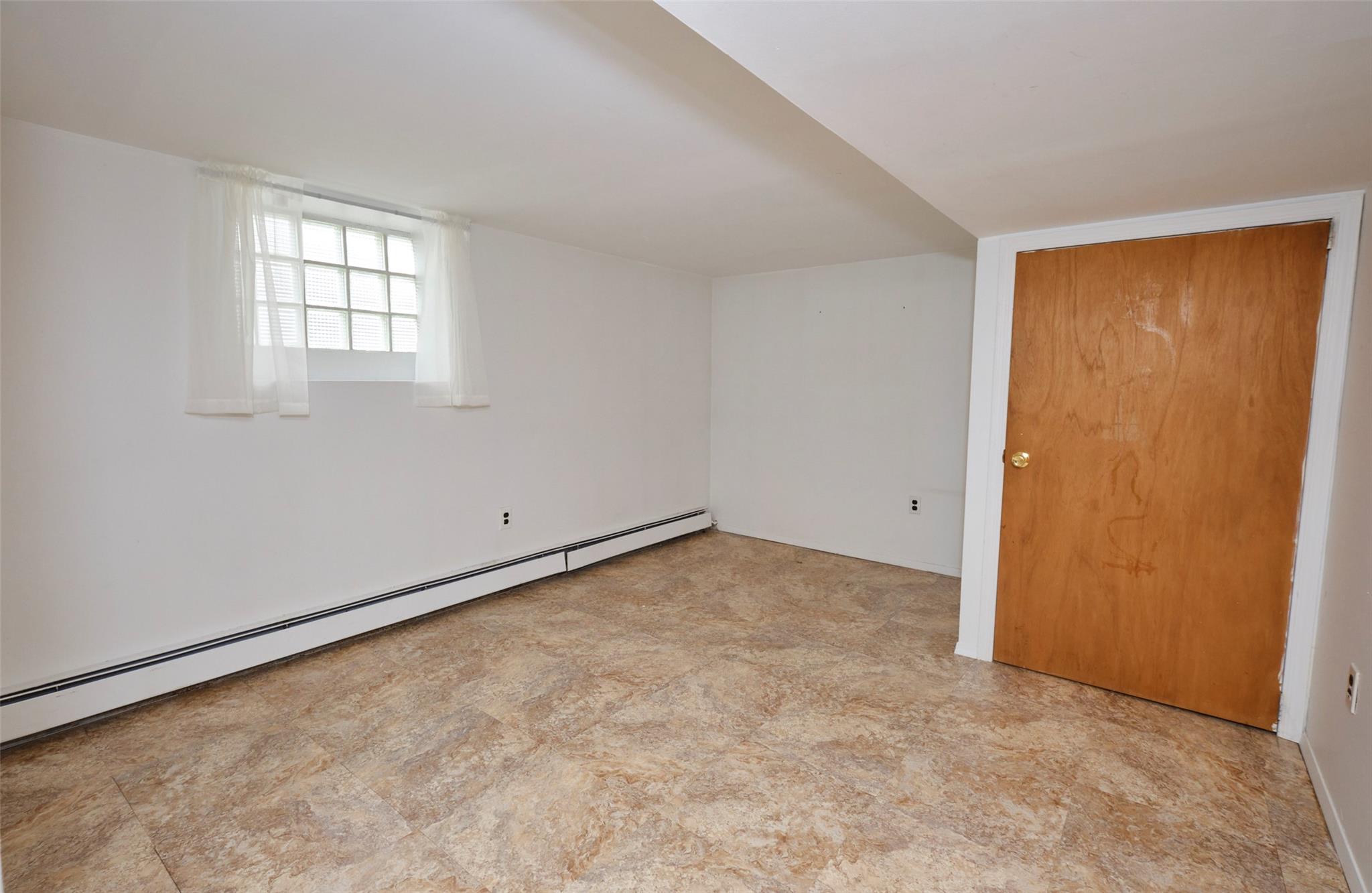 135-47 229th Street Queens, NY 11413 - Photo 28 of 36 Unfurnished room featuring a baseboard radiator