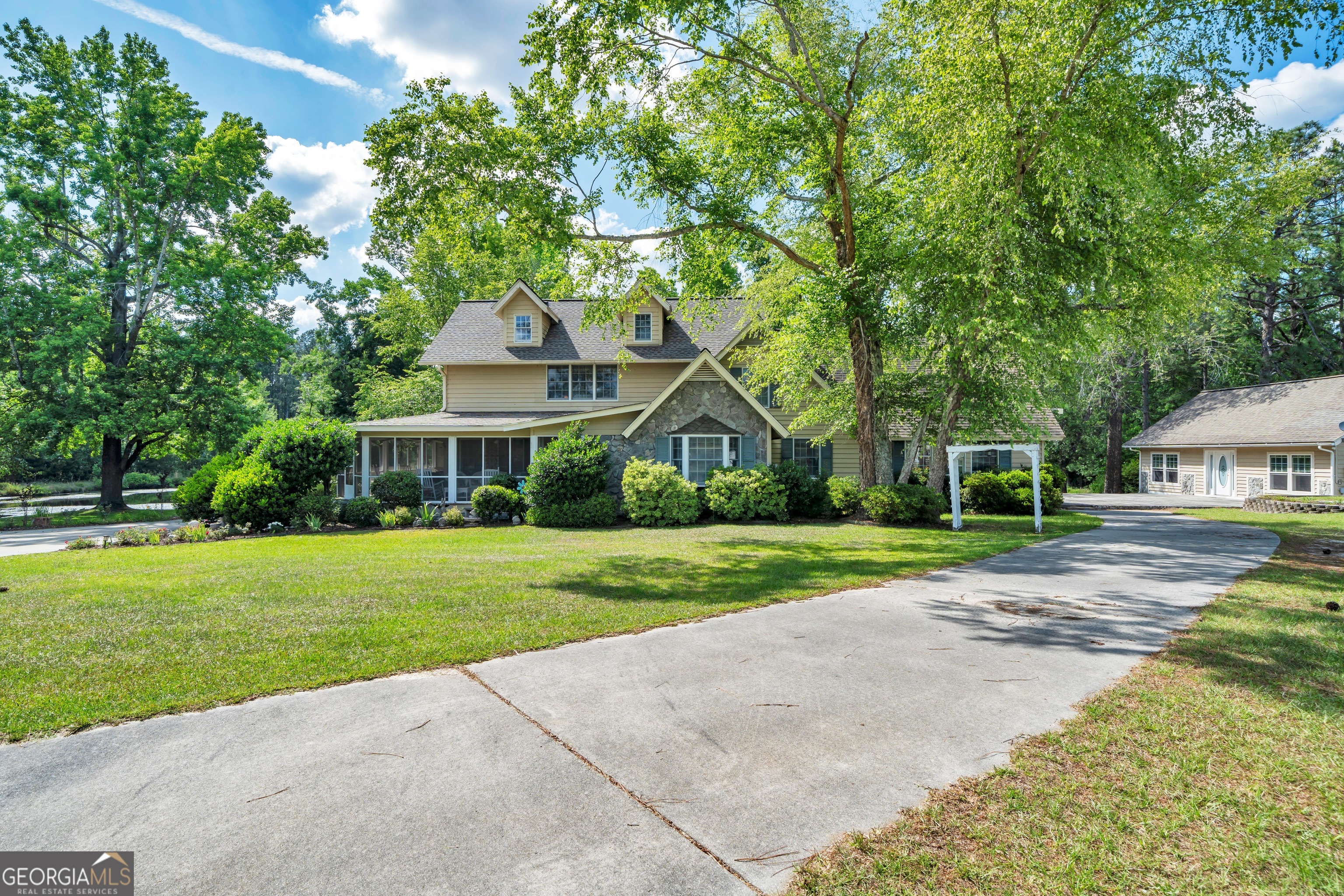 87 Georgia Avenue Adrian, GA 31002 - Photo 3 of 74 a front view of a house with a yard and trees