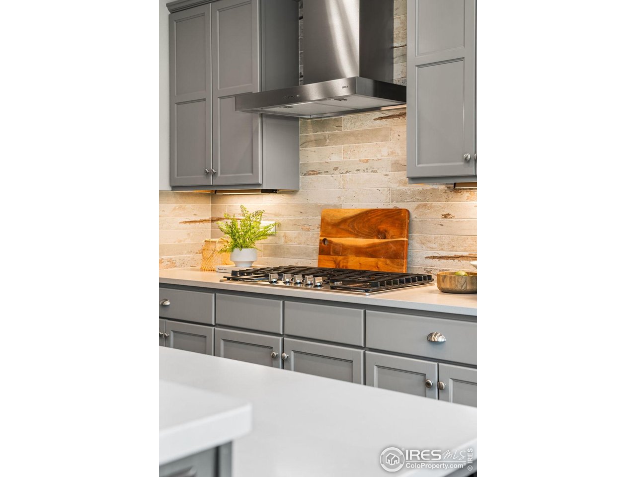 6977 Foxton Court Timnath, CO 80547 - Photo 13 of 32 a kitchen with granite countertop a sink and a stove