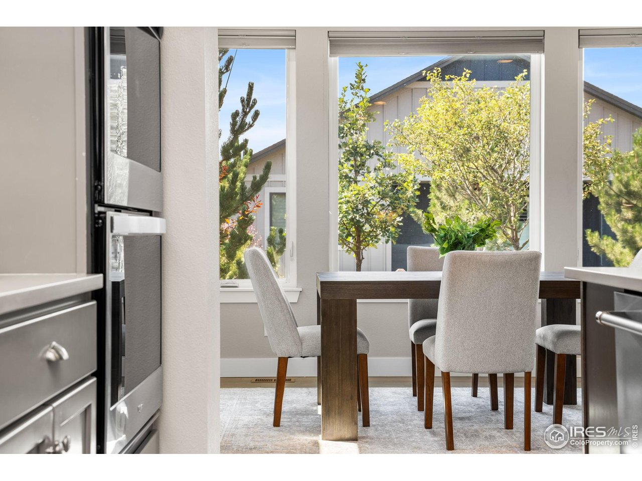 6977 Foxton Court Timnath, CO 80547 - Photo 17 of 32 a view of a dining room with furniture window and outside view