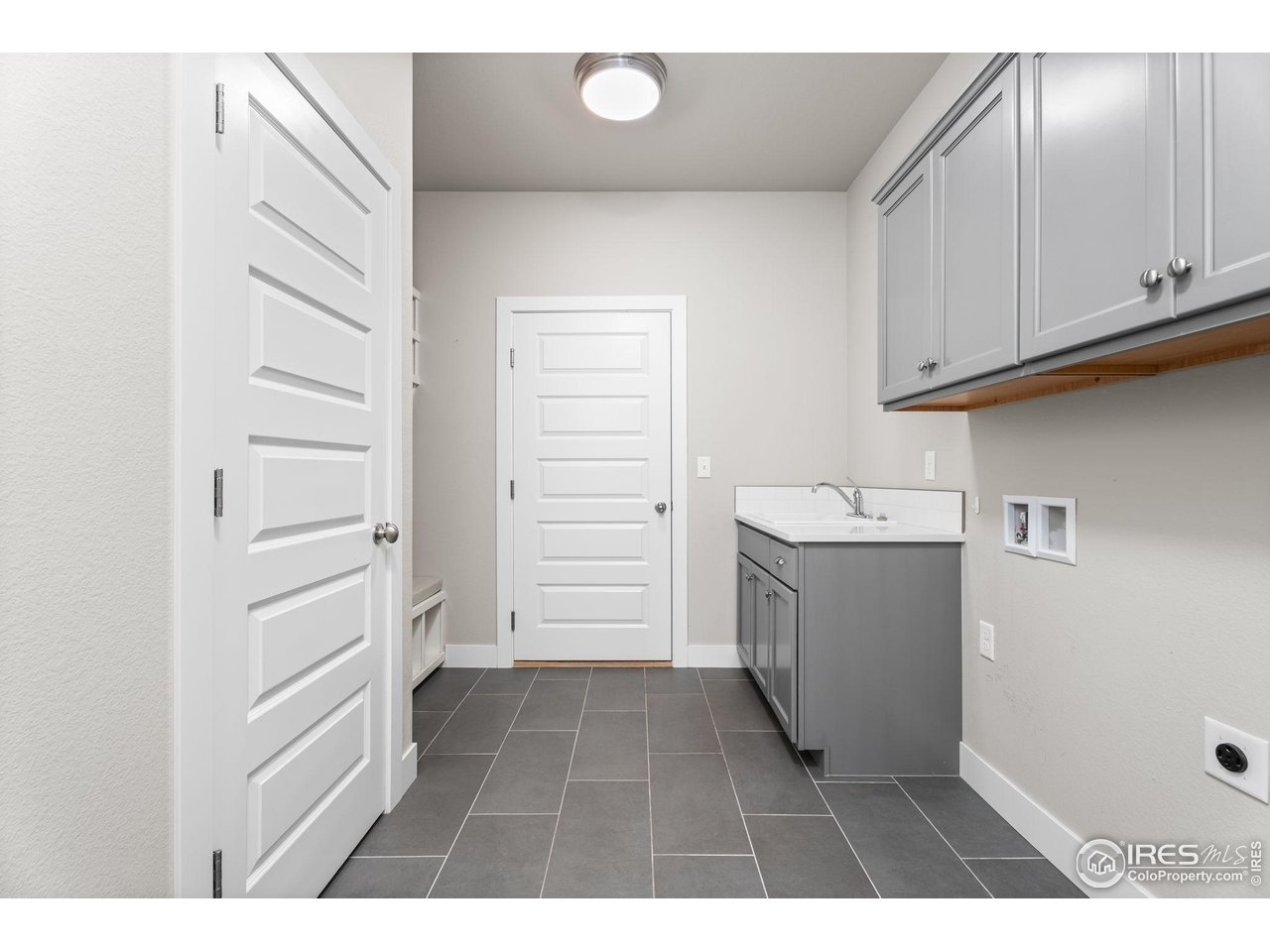 6977 Foxton Court Timnath, CO 80547 - Photo 20 of 32 a utility room with cabinets washer and dryer