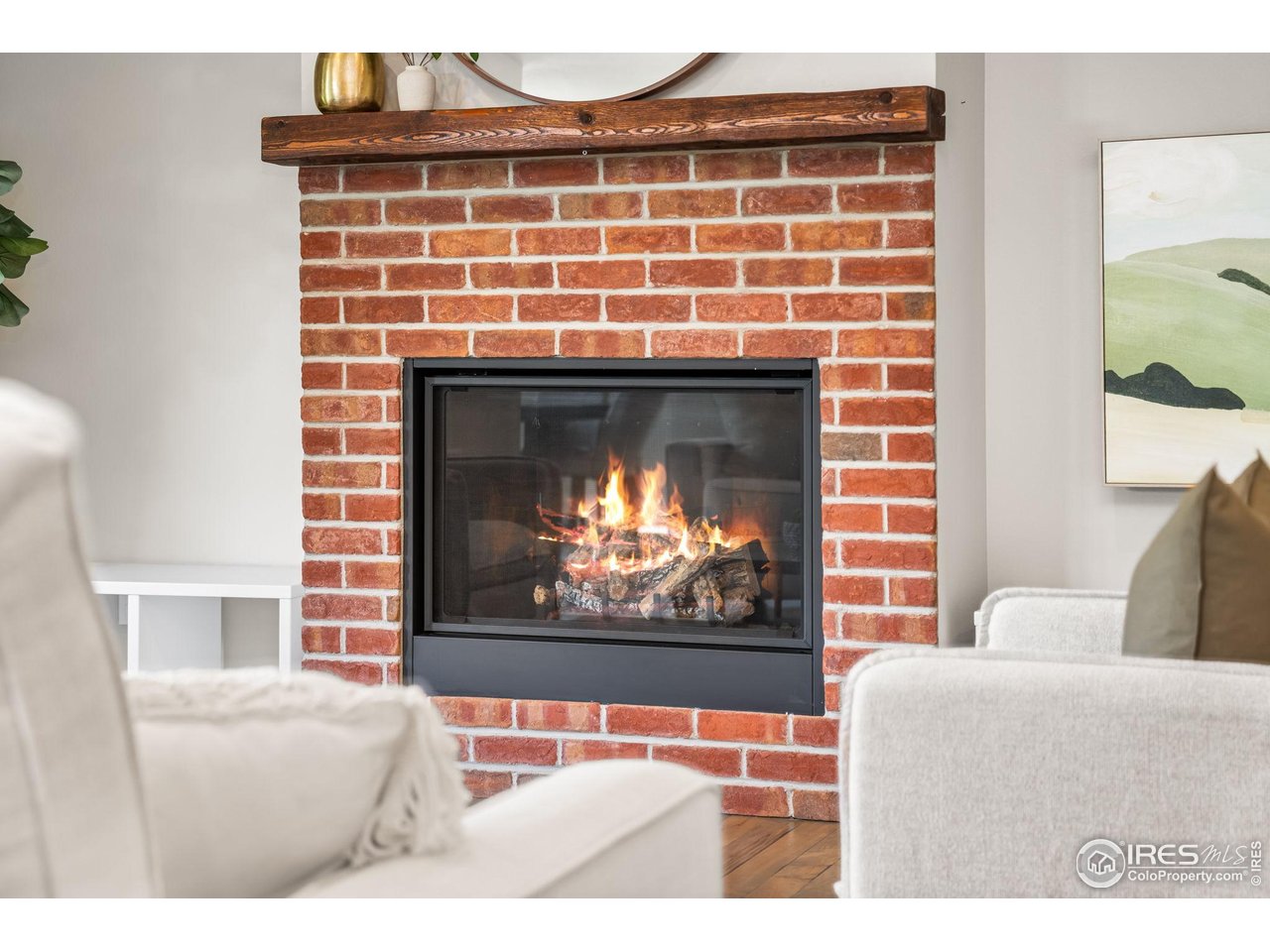 6977 Foxton Court Timnath, CO 80547 - Photo 8 of 32 a living room with furniture a fireplace and a flat screen tv