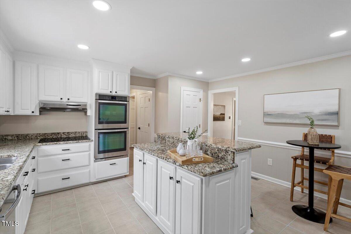 7300 Grist Mill Road Raleigh, NC 27615 - Photo 11 of 41 a kitchen with granite countertop a sink stove and cabinets