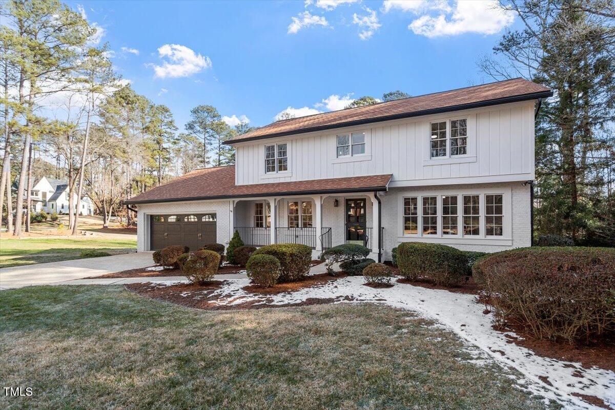 7300 Grist Mill Road Raleigh, NC 27615 - Photo 2 of 41 a view of a house with a yard chairs and table in a patio