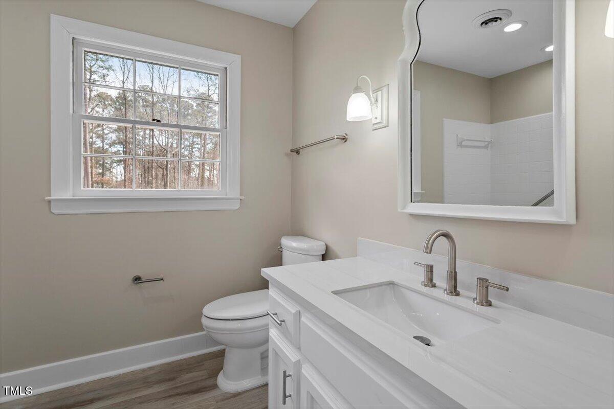 7300 Grist Mill Road Raleigh, NC 27615 - Photo 23 of 41 a bathroom with a toilet sink and mirror