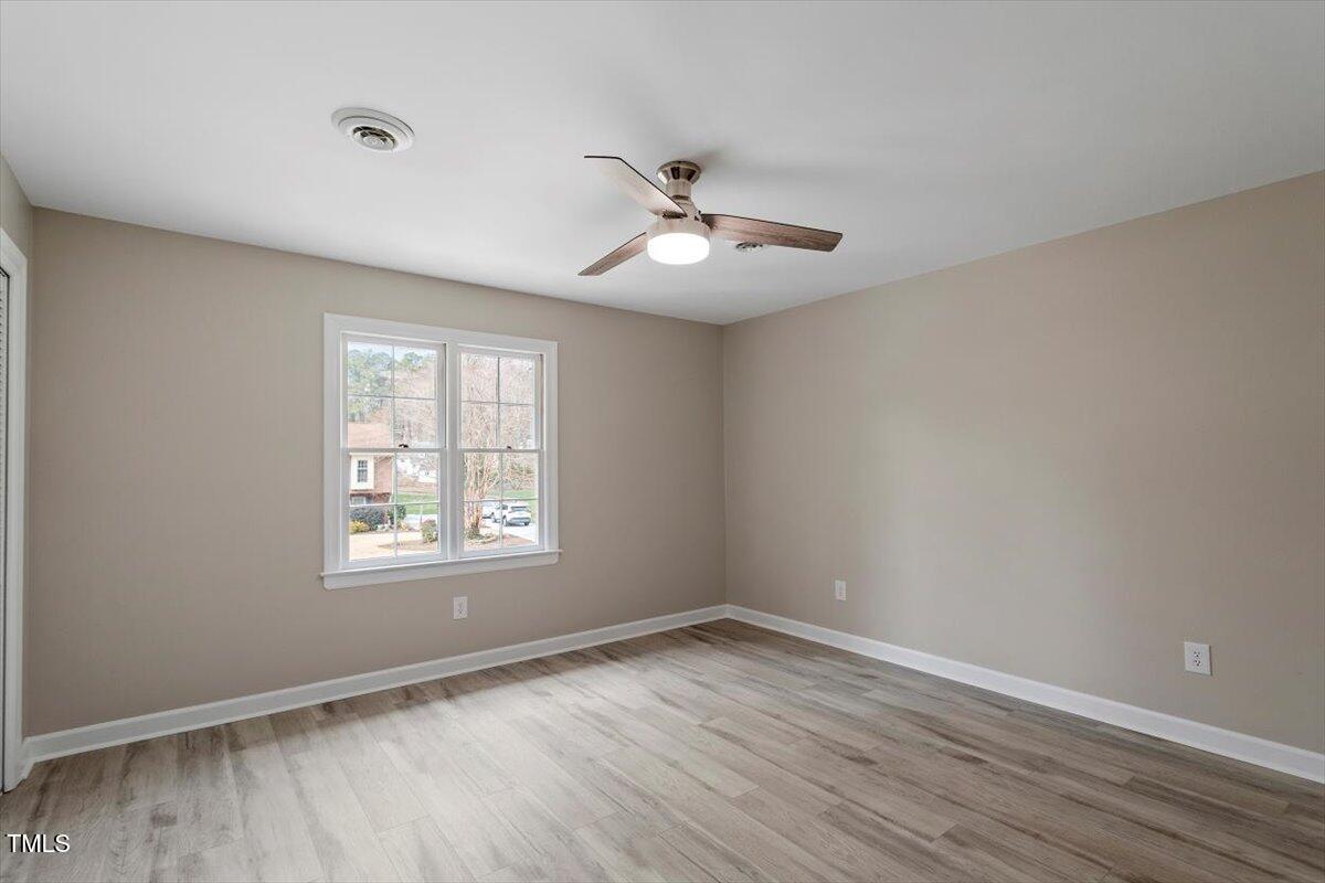 7300 Grist Mill Road Raleigh, NC 27615 - Photo 24 of 41 a view of empty room with wooden floor and fan