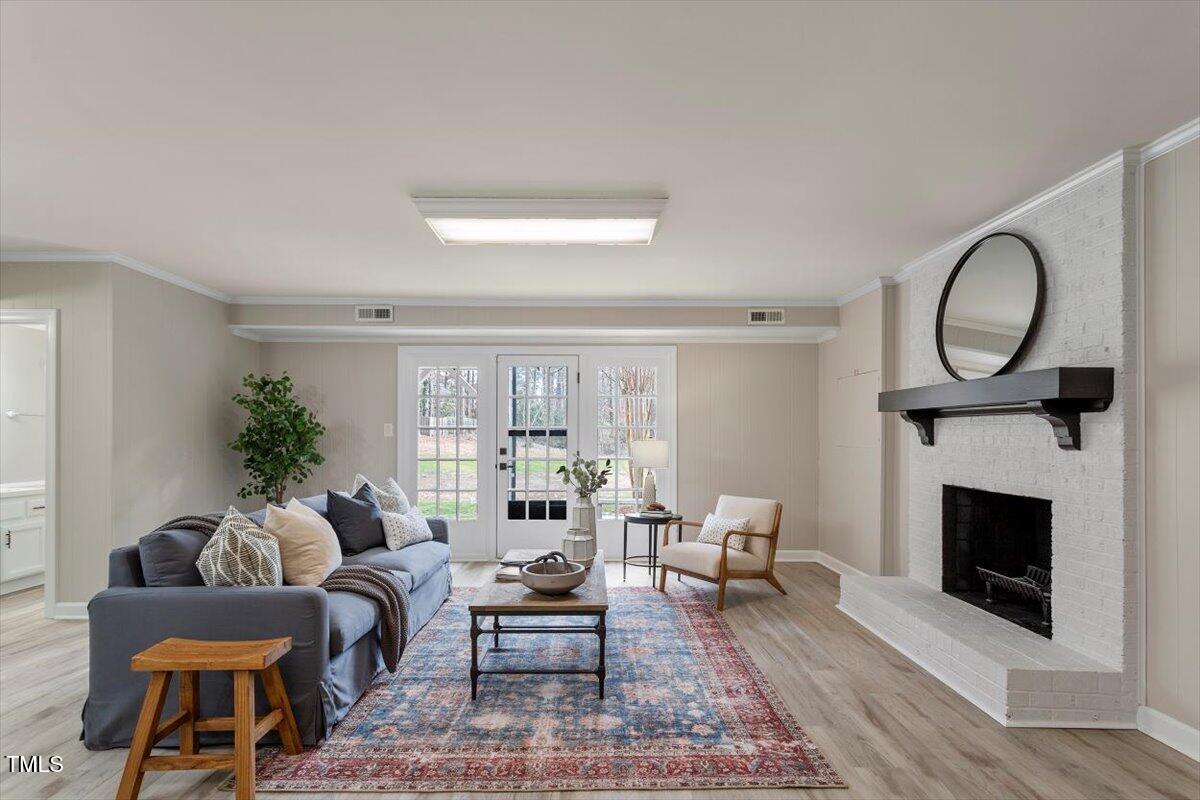 7300 Grist Mill Road Raleigh, NC 27615 - Photo 27 of 41 a living room with furniture a window and a fireplace
