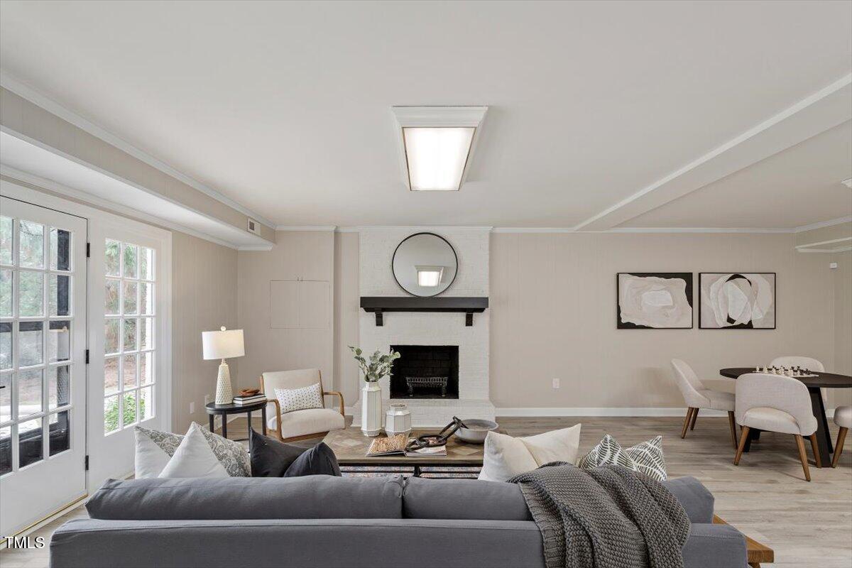 7300 Grist Mill Road Raleigh, NC 27615 - Photo 28 of 41 a living room with furniture and a fireplace